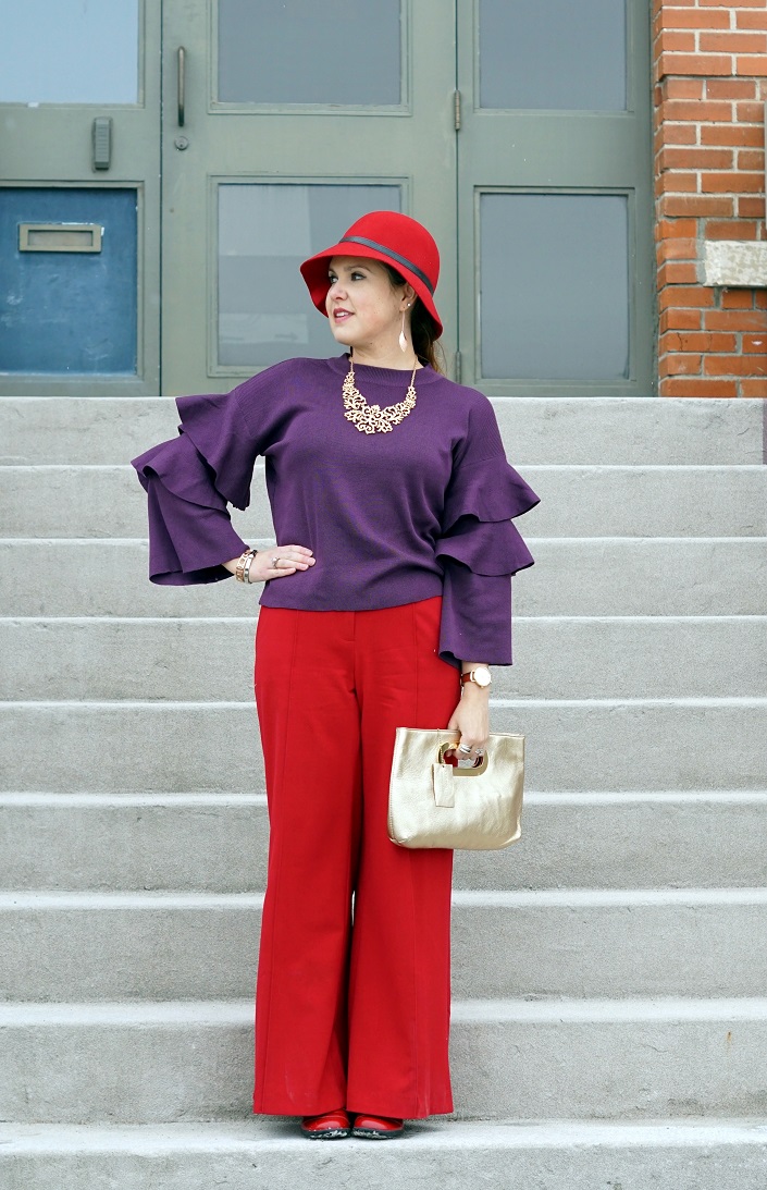 Winnipeg Style fashion stylist, Chicwish purple knit top with tiered sleeves, ThePeachBox roman numerial pink gold bangle, buckle silver bangle bracelet, Victoria Secret wide leg red pants, Danier leather gold clutch bag
